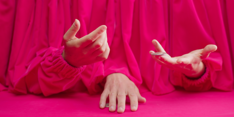 A pink curtain with three hands peeking out from underneath, playing with coins.